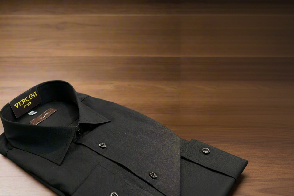 Folded black dress shirt with 'Vittoria' label on a wooden surface