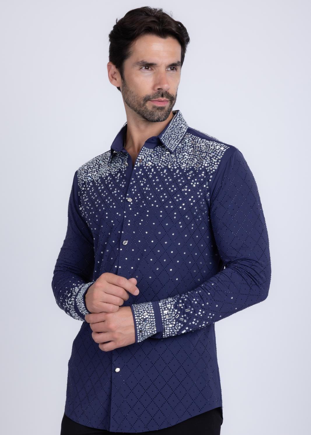 Man wearing a navy shirt with silver patterns on a white background