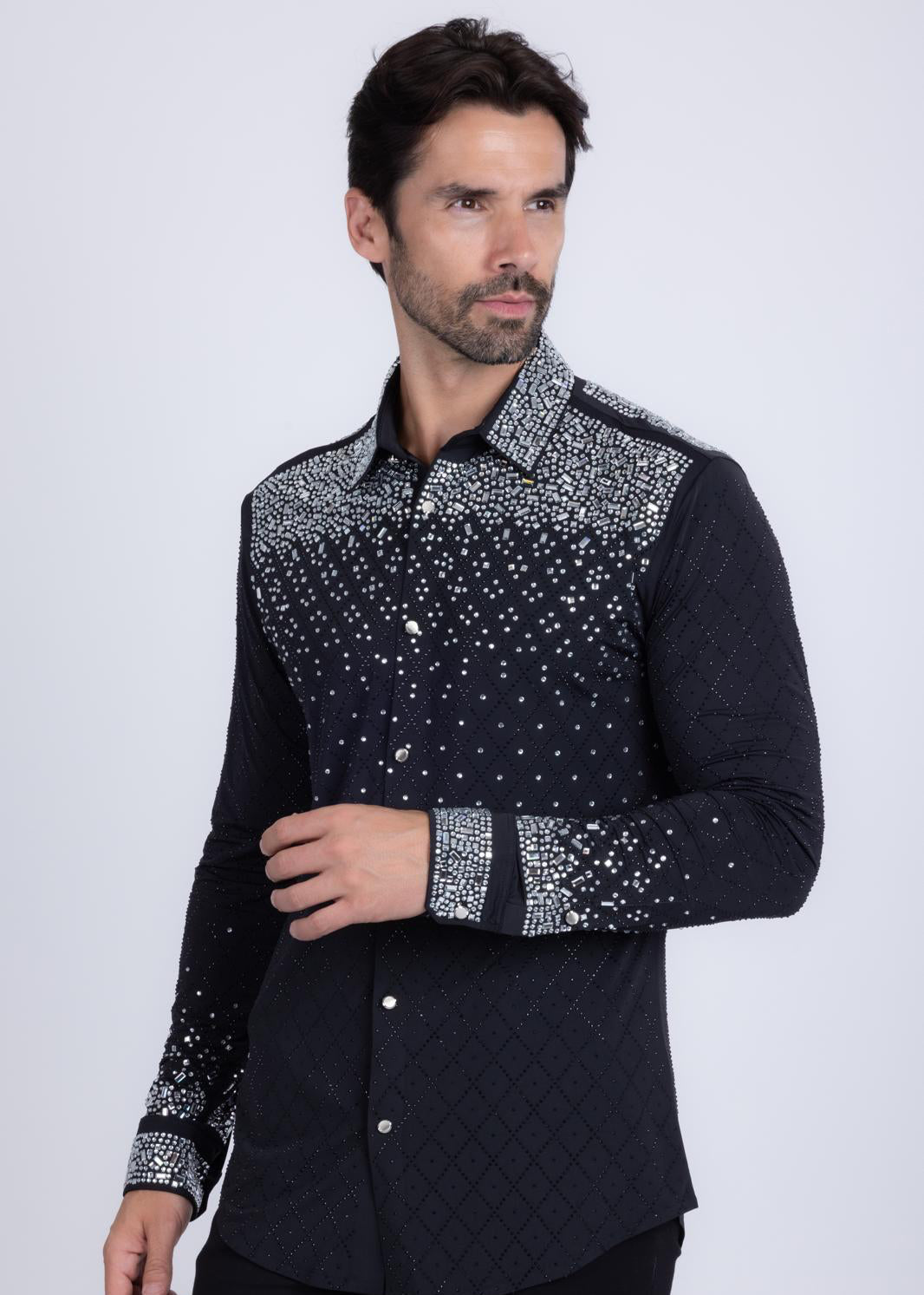 Man wearing a black shirt with silver embellishments on a white background