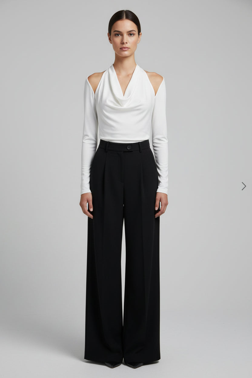 A two-piece jumpsuit with a white satin halter top and high-waisted black wide-leg trousers displayed on a mannequin.