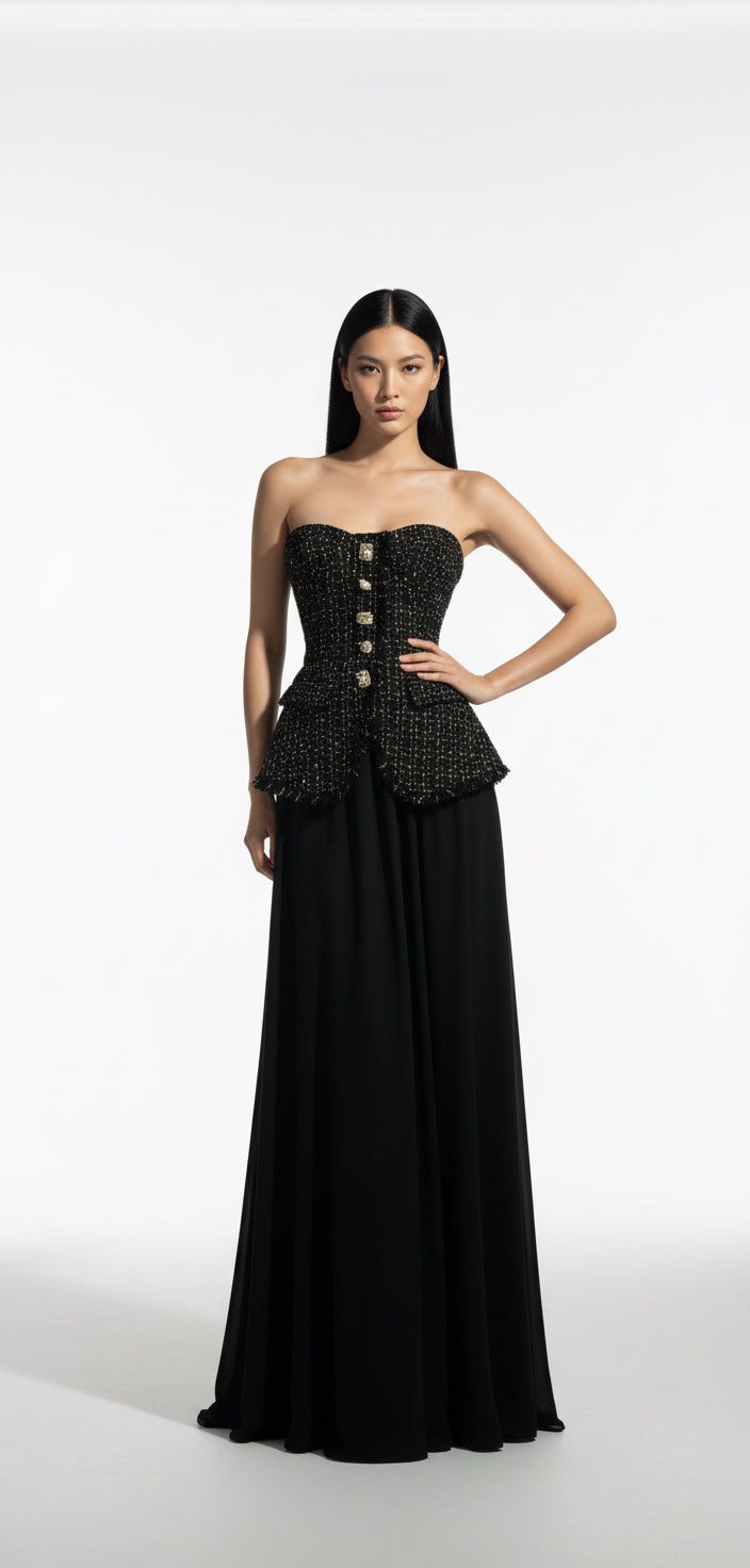  black strapless gown with intricate detailing on a white background