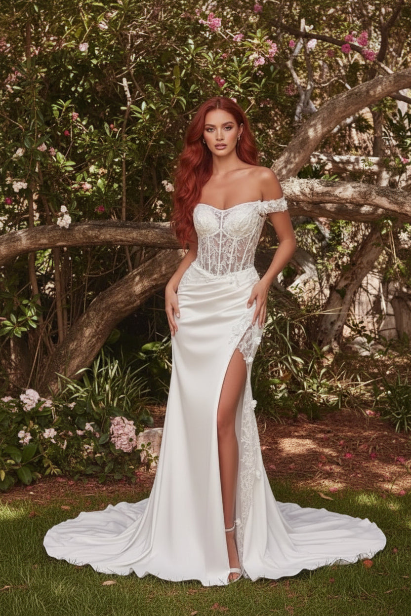 Woman wearing a white lace off-shoulder dress in a natural setting.